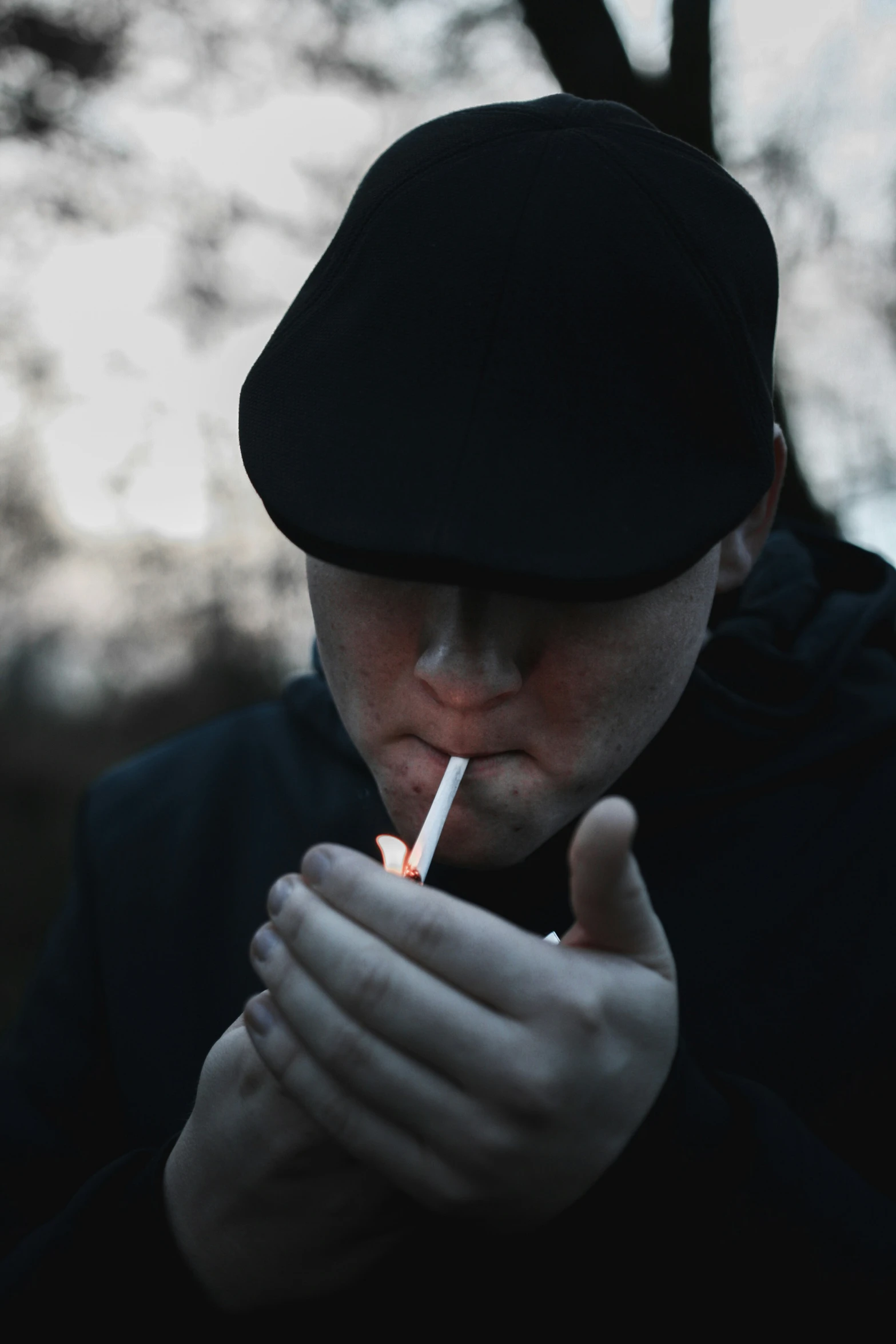 a man is smoking outside at night in the daytime