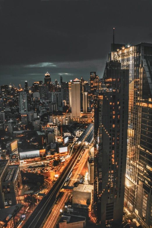 large city at night with a train in the foreground