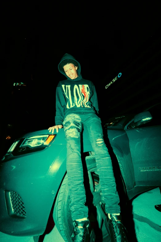 a person sitting on a skate board in the dark