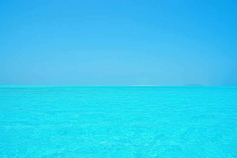 a man swimming on the blue water in the ocean