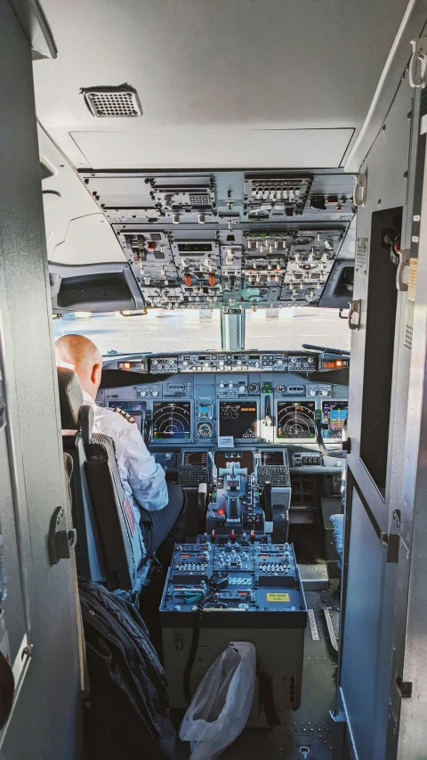 an airplane cockpit with several controls panel and two pilots sleeping