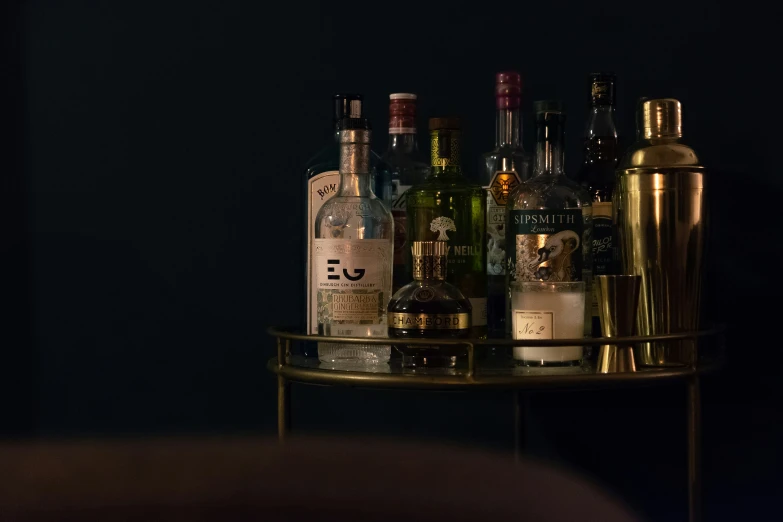 several bottles of alcohol sit on a stand