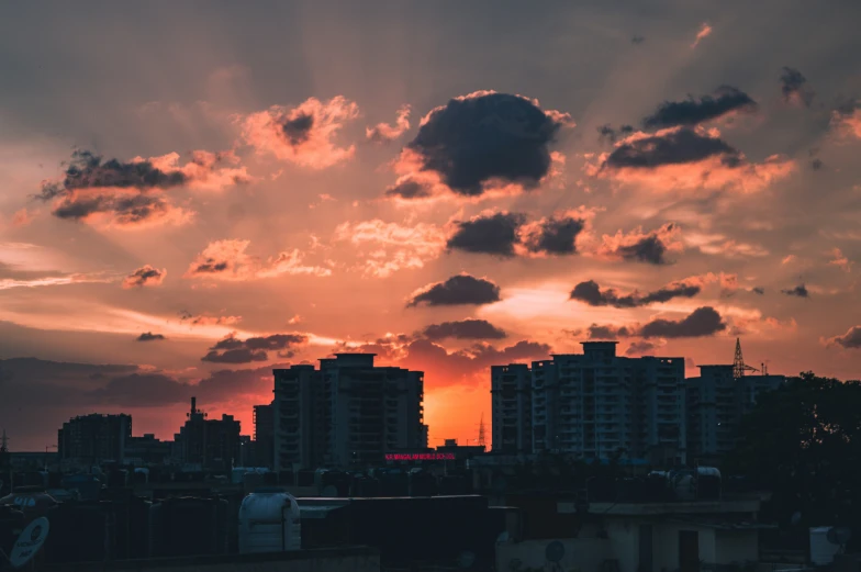 a red and yellow sunset shines in the city