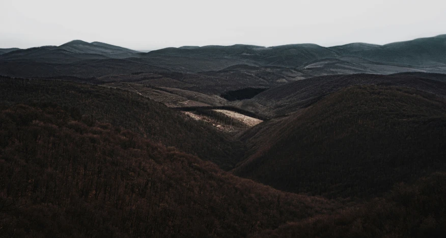 landscape pograph with hills, water and a small lake