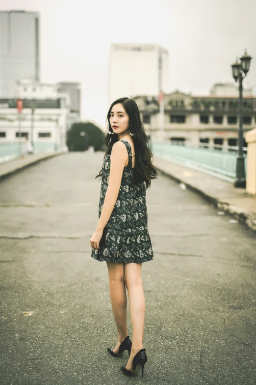 a woman standing alone in an empty alley