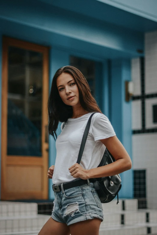 a woman with her back turned carrying a camera