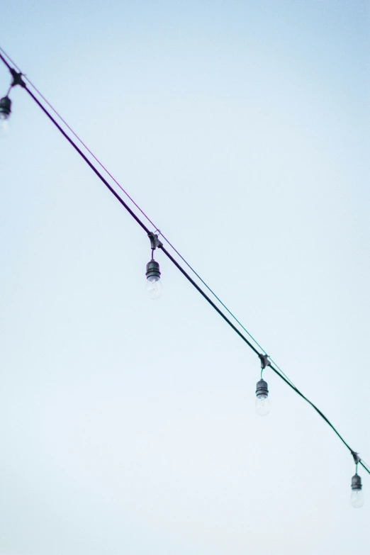 traffic lights on pole are lit up with green wires