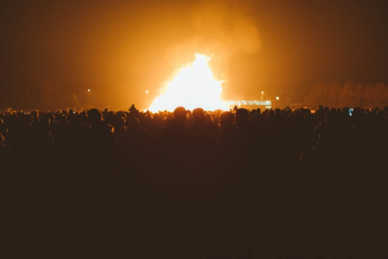 an image of people gathered by a fire