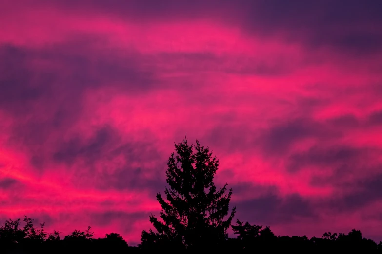 the sky is covered in a pink, purple and blue hue