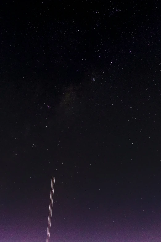 a plane flying through the air with stars