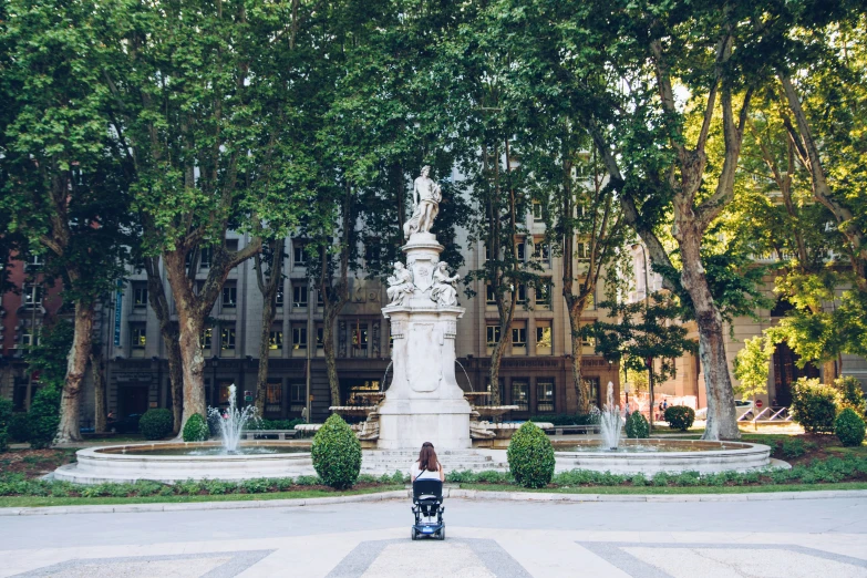 a  is standing next to a statue