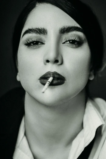 a woman smoking cigarette on a black and white po