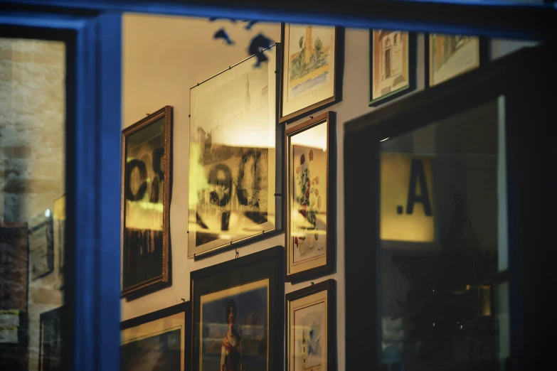 a very large wall full of framed pictures