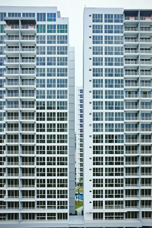 an airplane flies past some very tall building