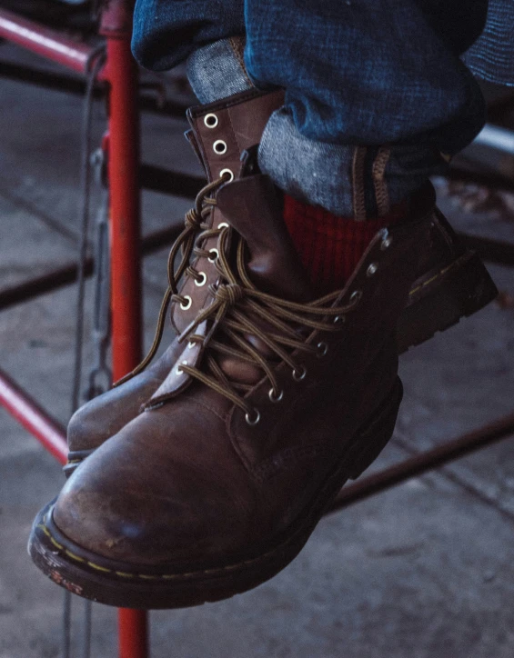 a close up s of someones boots on a sidewalk