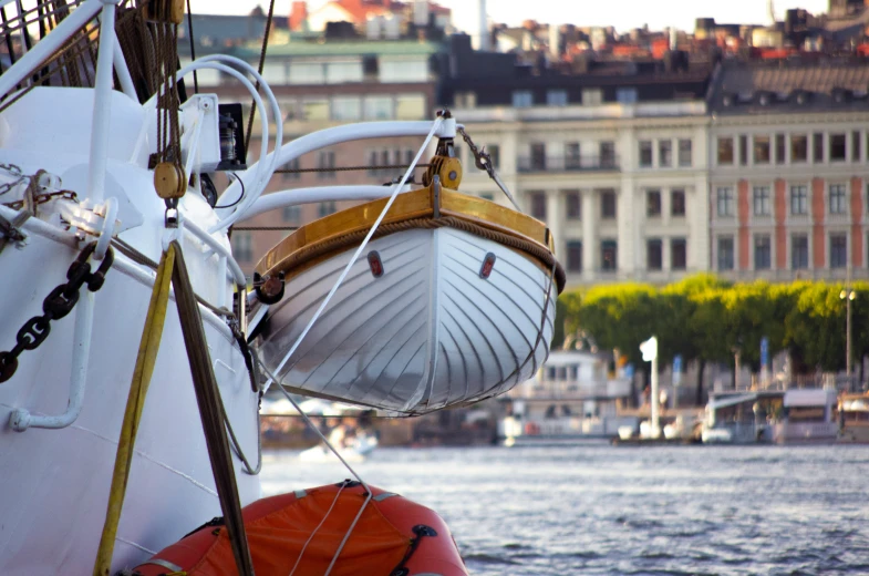 a boat with yellow trim is moored in the bay