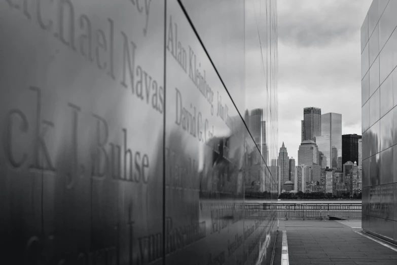 the reflection of skyscrs in a glass wall