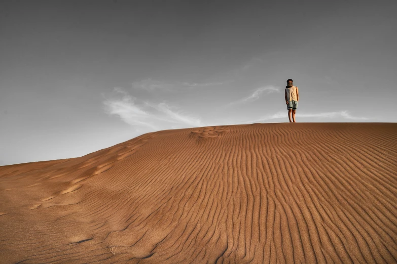 a man stands on top of a hill