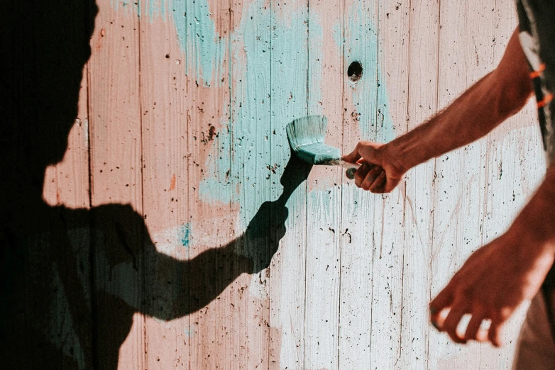 the shadow of a man and a person holding onto a cell phone