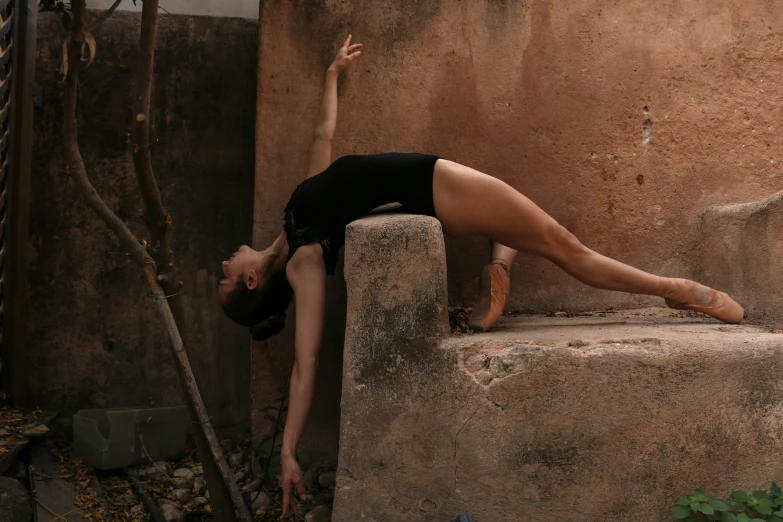 a woman is leaning up against a wall