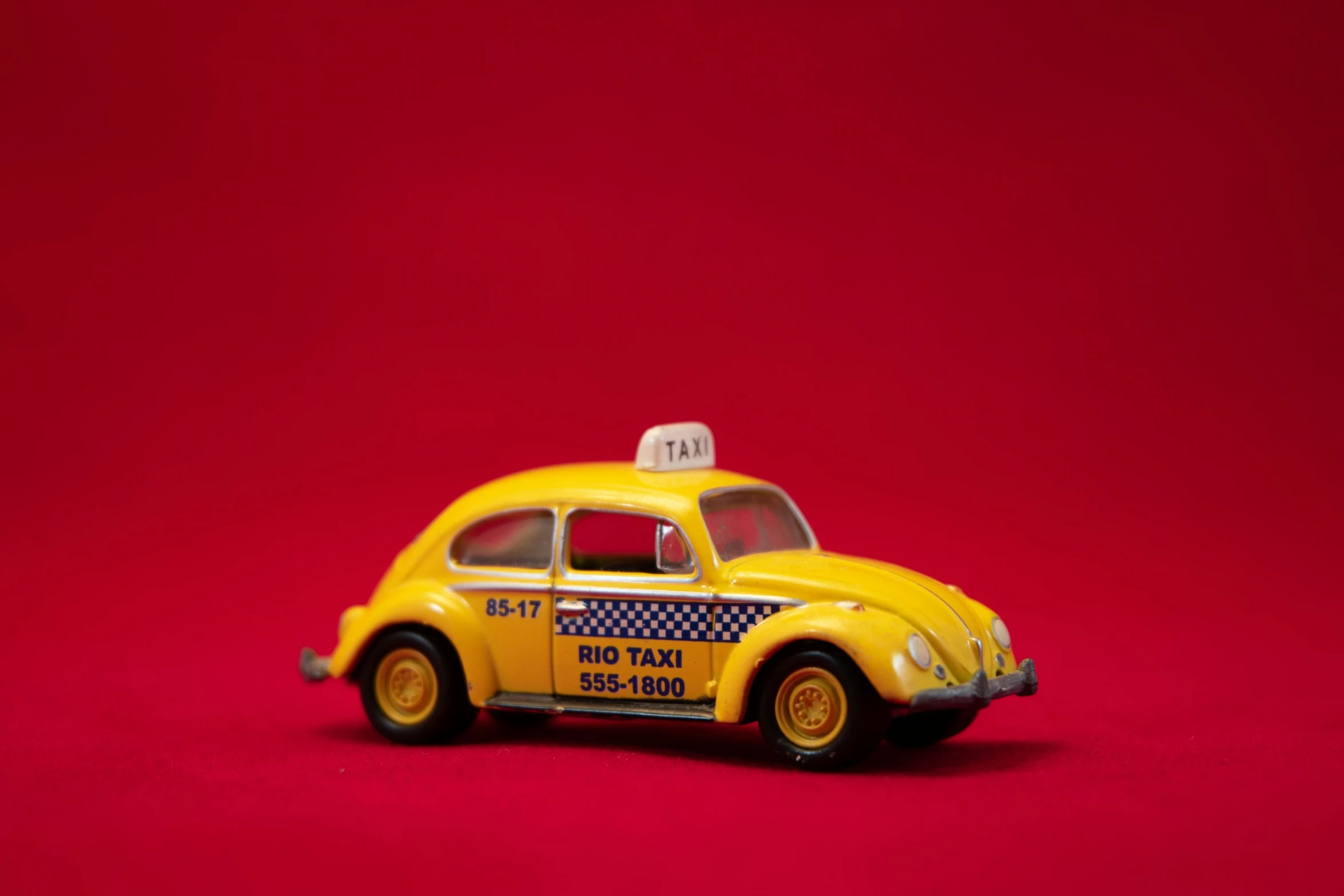 a yellow taxi cab on a red background