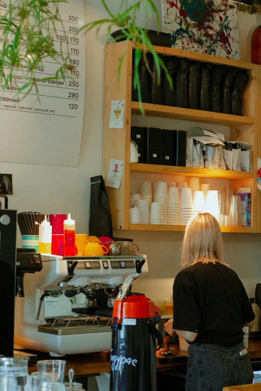 a woman is working in a coffee shop