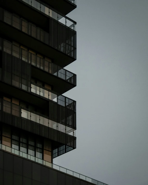 a large jet flying by a tall building