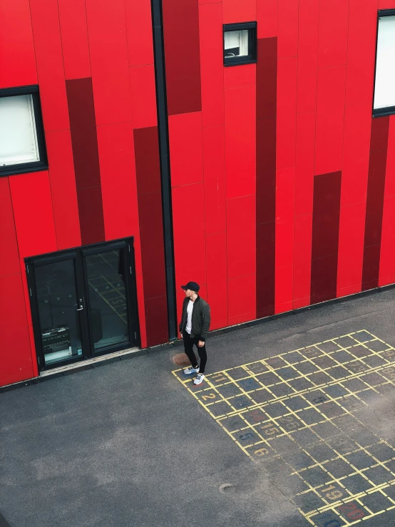 two people in front of an outdoor red building