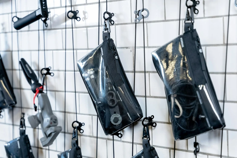 bags hanging on a wall next to various wrenches