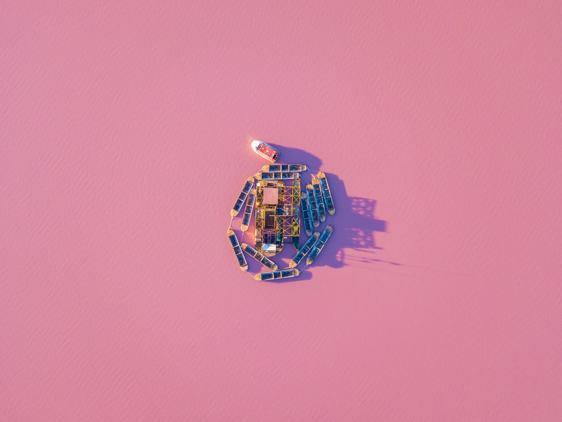 an aerial po of a toy boat on a pink surface