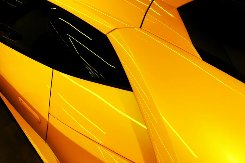 the hood of a modern looking, yellow car