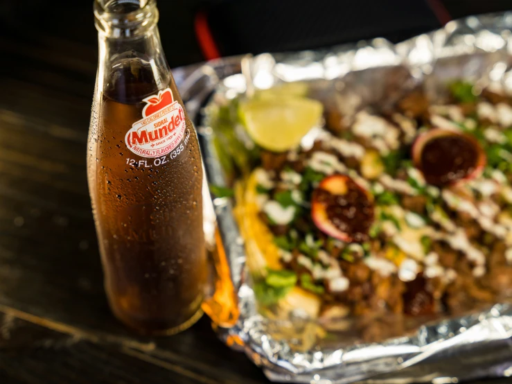 a pizza and a soda that is sitting on the table