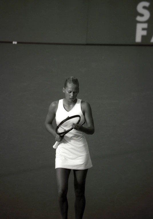 a woman is holding a tennis racket in her hands