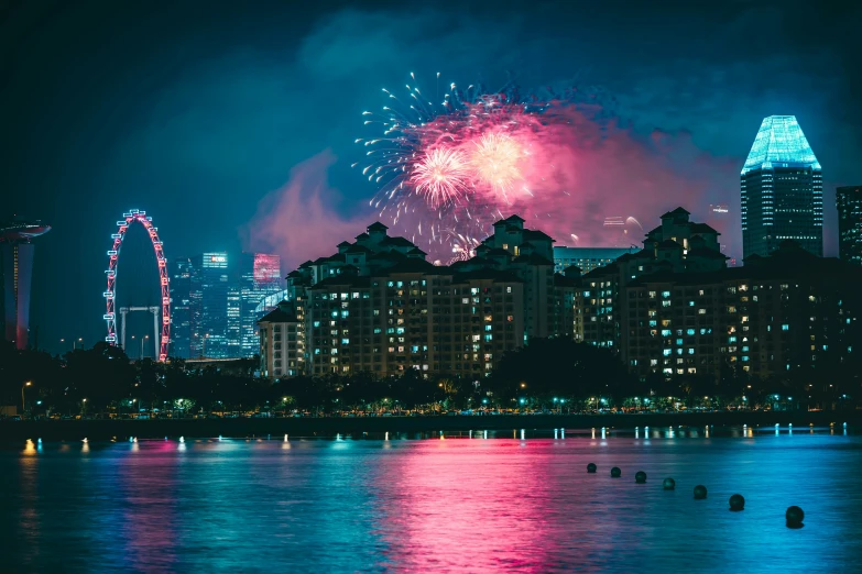 a large fireworks is coming from behind buildings