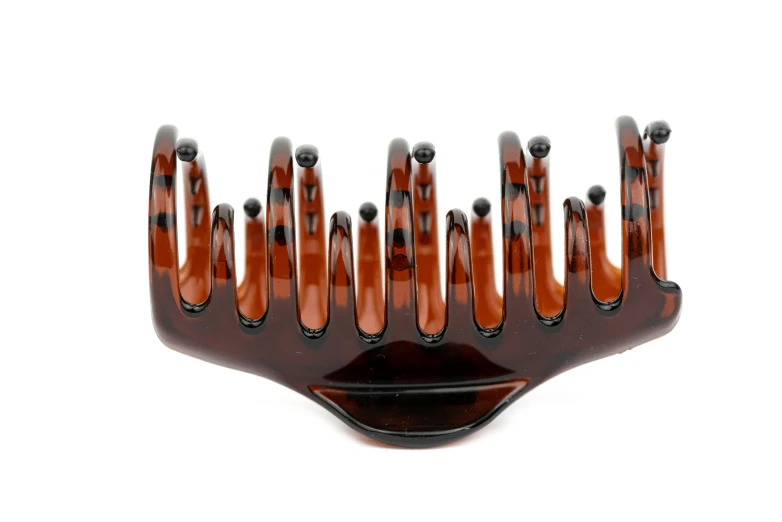 a plastic hair comb with holes on the top of it
