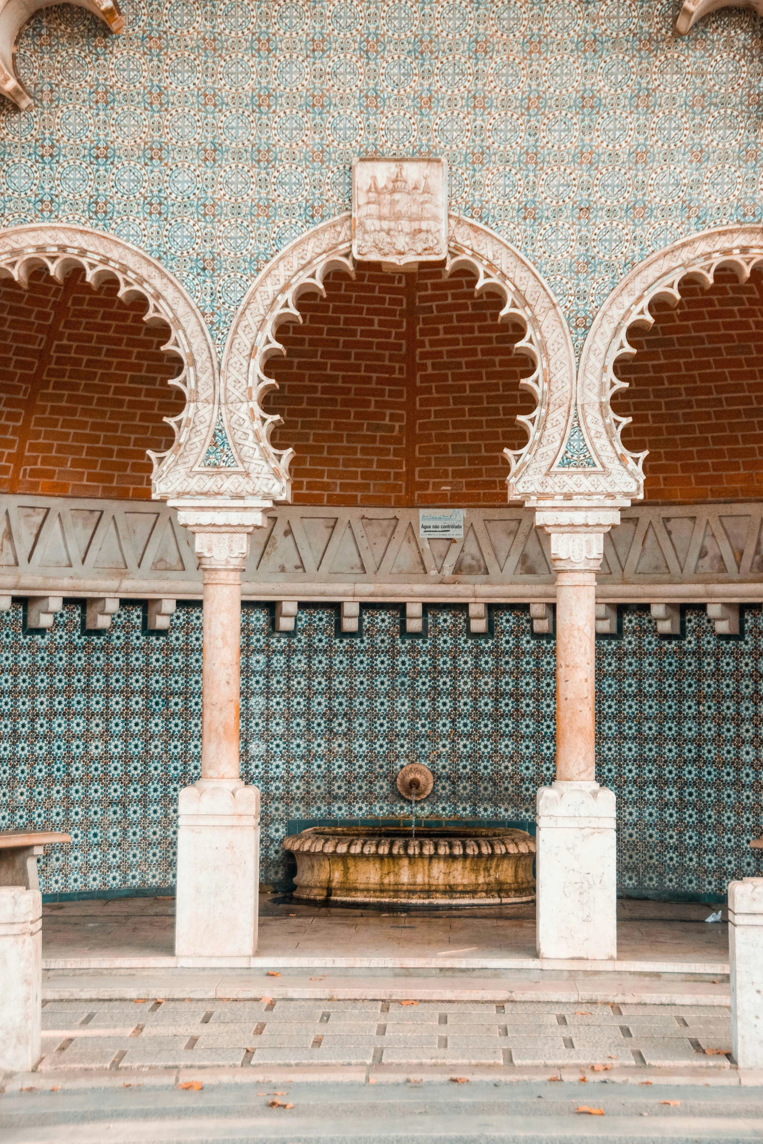 a stone bench and a building with a tiled floor