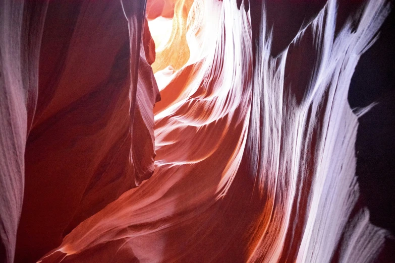 a room in a narrow area with high, wavy rocks