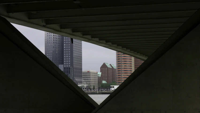 a view of the city skyline from underneath a bridge