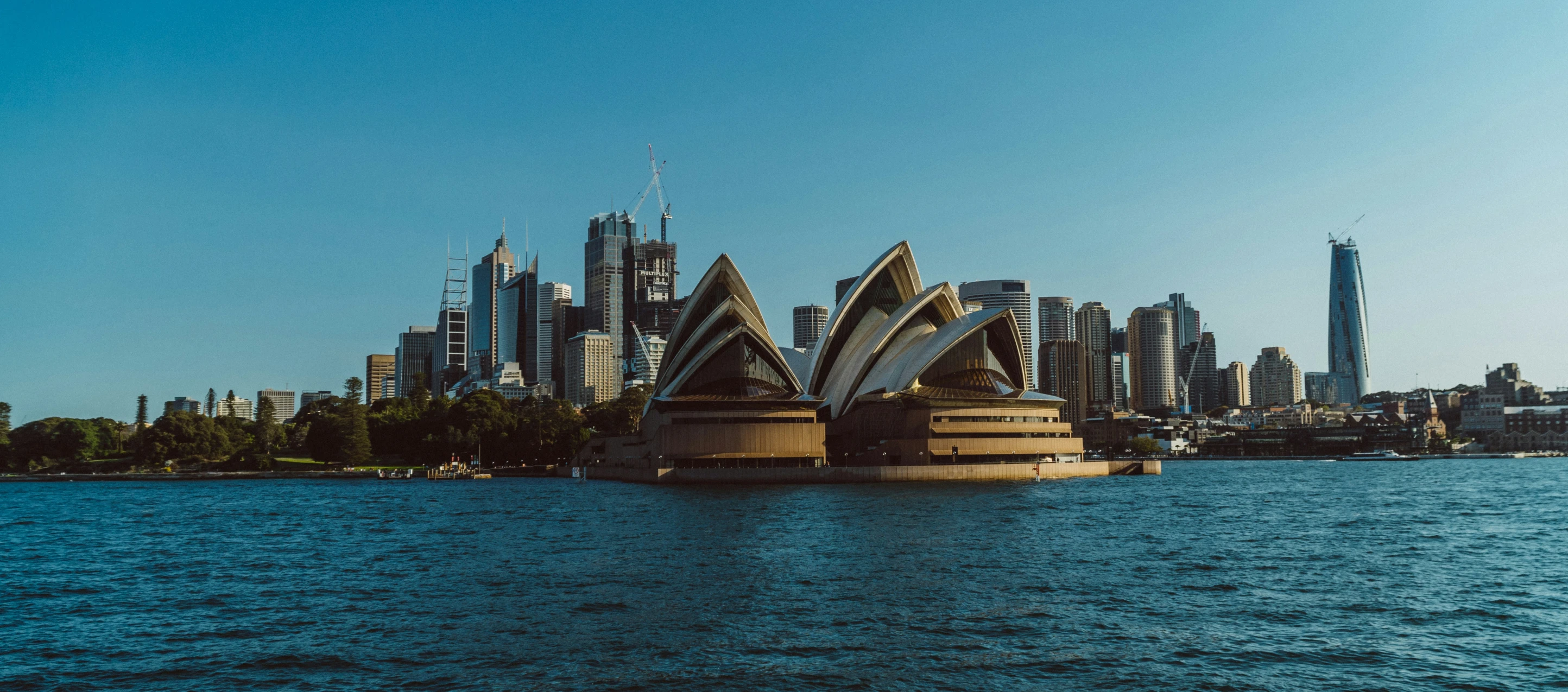 an image of some water and buildings in the distance