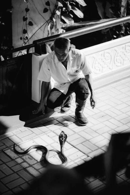 black and white po of a man sitting on a bench