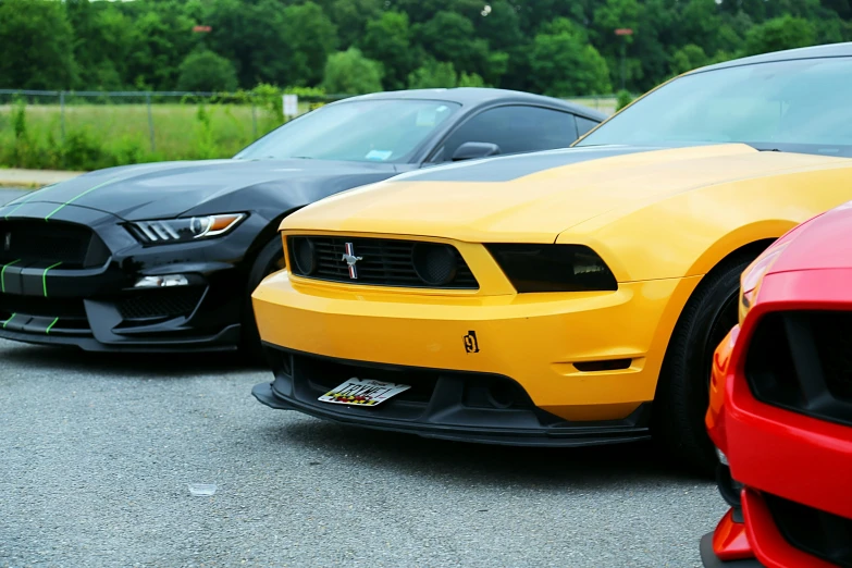 three cars sit in a row on a parking lot