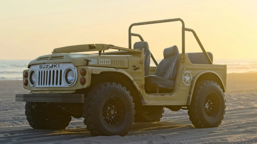 a yellow jeep that is sitting on a beach