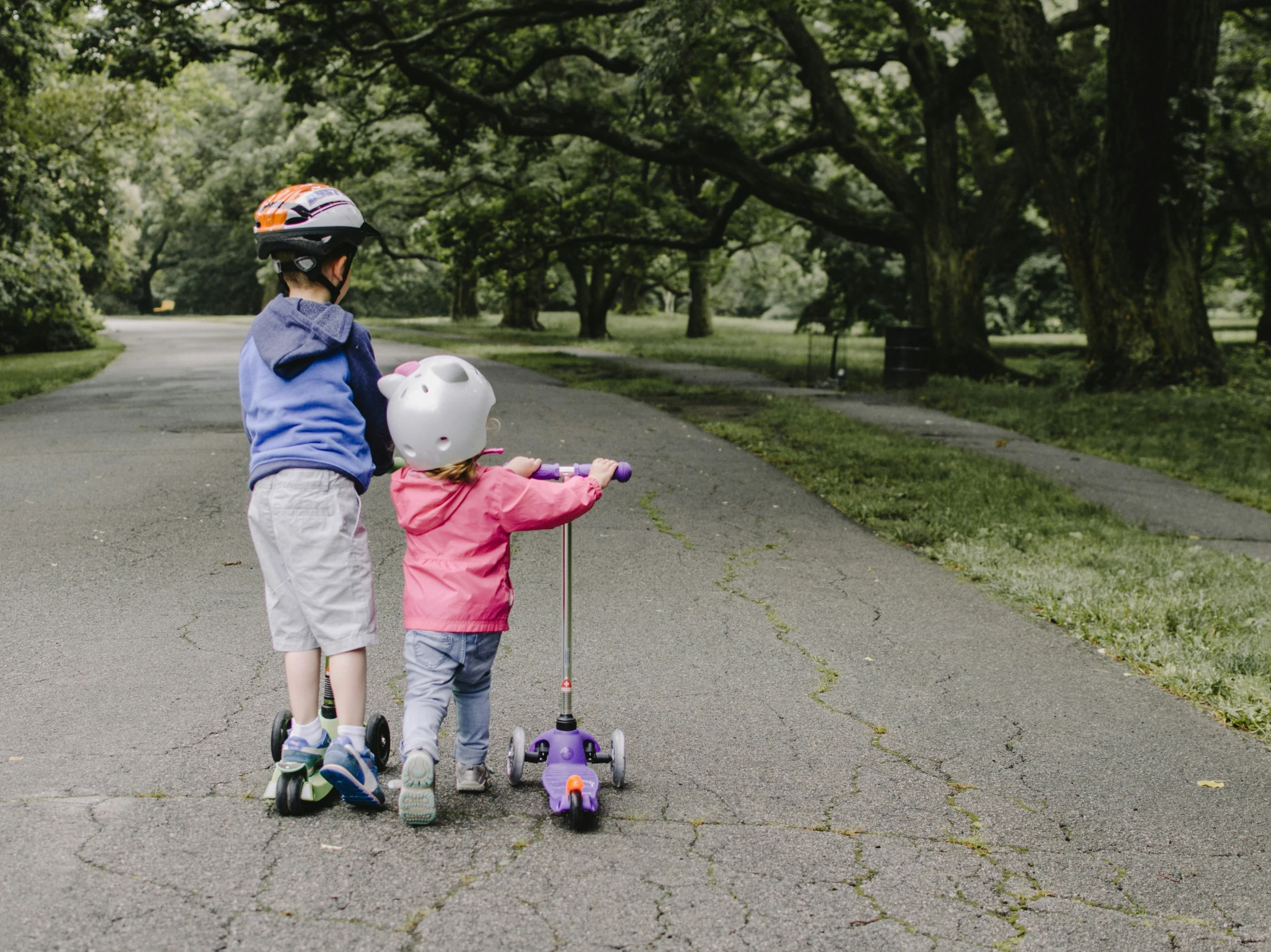 two children on h carts in the middle of a road