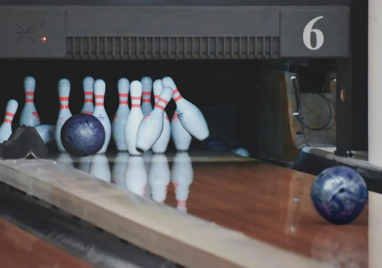 a bunch of bowling pins leaning against each other