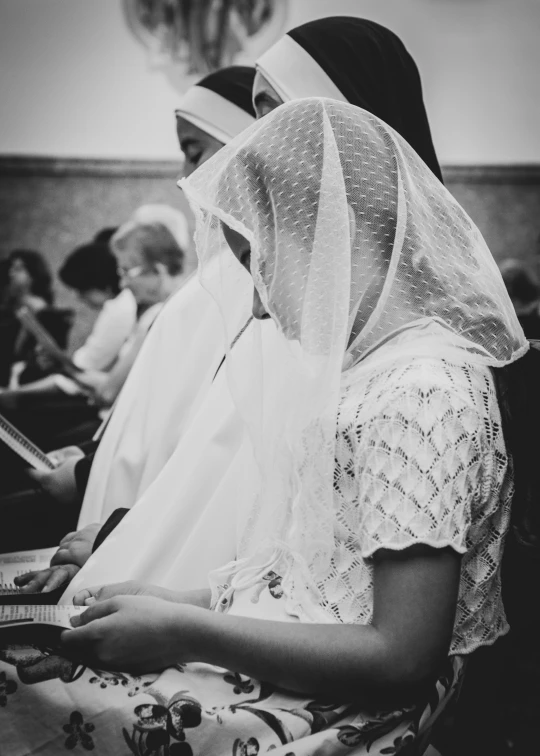 black and white po of people with veils in their heads