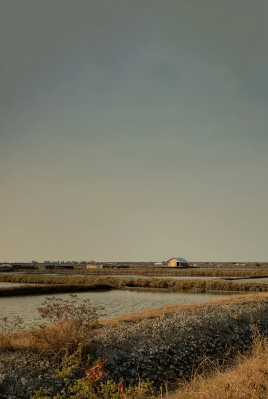 an abandoned house on a beach near water