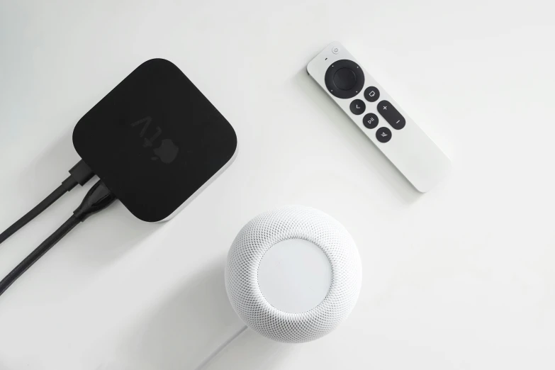 an apple tv remote, keyboard and wireless mouse