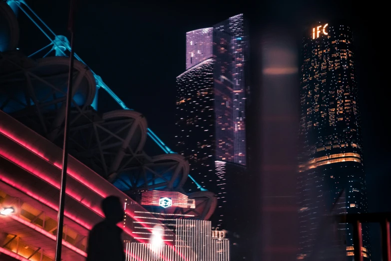 a person walking down a city street at night