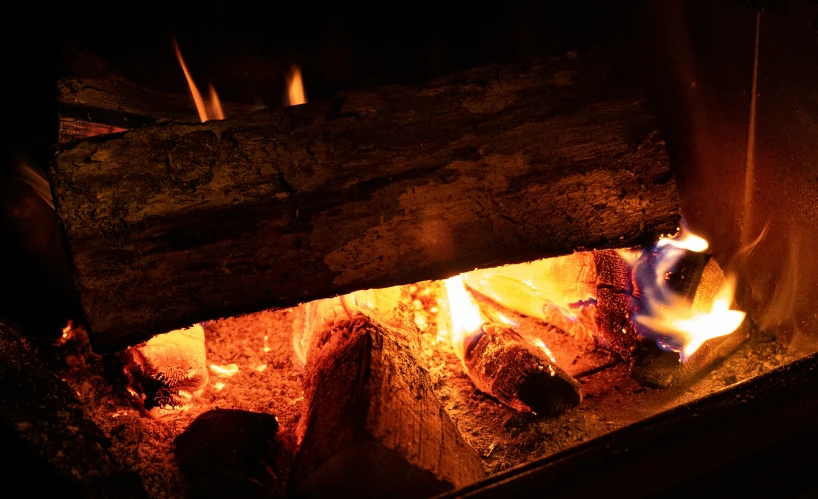 an image of a lit fireplace in the dark