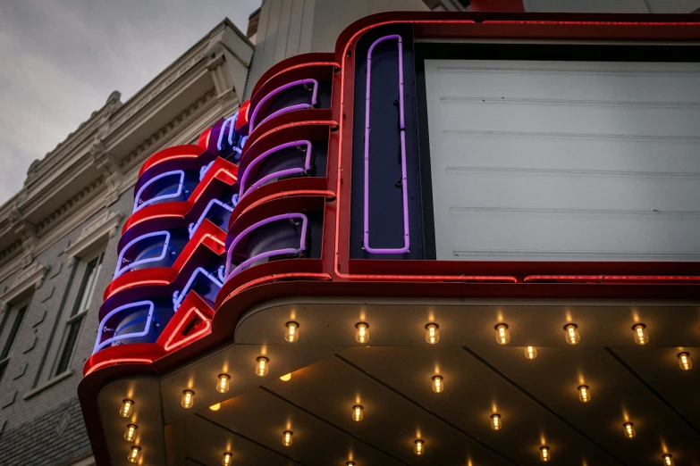 an old theater sign in red and blue